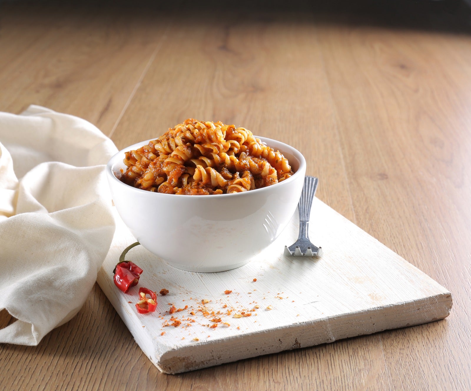 Spicy Pasta served in a white bowl.